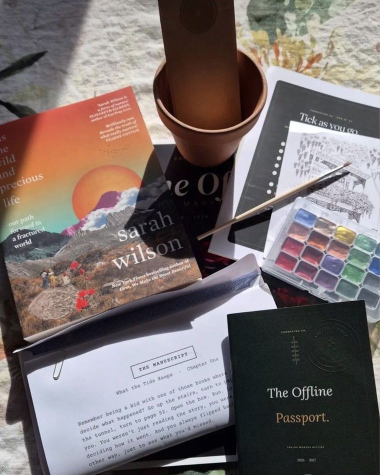 An Offline Box opened at home: a book, watercolours, a terracotta pot and The Offline Passport