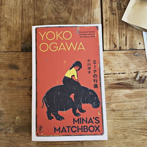 A novel from a past box resting on a linen cloth